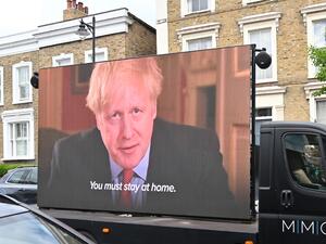 A big screen organised by British political campaign group Led By Donkeys mounted on a vehicle plays a clip from Britain's Prime Minister Boris Johnson's March 23 address to the nation where he explained the stay-at-home coronavirus lockdown rules outside the home of Number 10 Downing Street special advisor Dominic Cummings in London on May 24, 2020 following allegations Cummings broke coronavirus lockdown rules by travelling across the country in March. British Prime Minister Boris Johnson was under increa