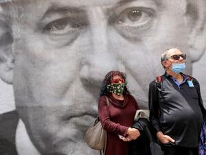 Israeli protesters rally against Prime Minister Benjamin Netanyahu outside his residence in Jerusalem on May 24, 2020. The veteran premier, who has just forged a unity government after over a year of political turmoil, now faces the next challenge -- being the country's first premier to face criminal charges while in office. Netanyahu addressed reporters before entering the Jerusalem District Court where he was to face charges of bribery, fraud and breach of trust. He condemned the "fabricated and ludicrous
