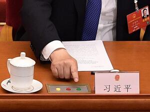 Chinese President Xi Jinping votes on a proposal to draft a security law on Hong Kong during the closing session of the National People's Congress at the Great Hall of the People in Beijing on May 28, 2020. China's rubber-stamp parliament endorsed plans May 28 to impose a national security law on Hong Kong that critics say will destroy the city's autonomy. NICOLAS ASFOURI / AFP