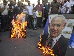 Palestinian demonstrators burn pictures of US President Donald Trump and Israeli Prime Minister Benjamin Netanyahu during a demonstration against the plans to annex parts of the occupied West Bank on May 30, 2020, in Nablus in the occupied West Bank. JAAFAR ASHTIYEH / AFP