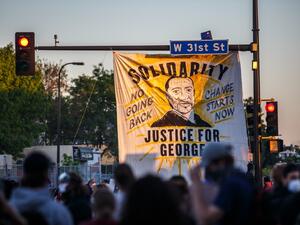 A banner depicting George Floyd is hanged to a street light during a demonstration to call for justice for George Floyd, a black man who died while in custody of the Minneapolis police, on May 30, 2020 in Minneapolis, Minnesota. (DELIL SOULEIMAN / AFP)