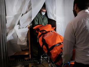 The body of a coronavirus victim is transported to a refrigerated container at a funeral home in Queens on April 29, 2020 in New York City. The funeral home, which serves a busy and diverse community in Queens, has been overwhelmed with the deceased from COVID-19. (AFP/File)
