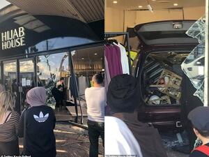 In footage of the incident, the driver of the SUV ploughed into another, smaller car, before driving directly into the shopfront. (Twitter)