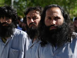Taliban prisoners stand during their release from the Bagram prison, next to the US military base in Bagram, some 50 km north of Kabul on May 26, 2020. Afghan authorities plan to release 900 more Taliban prisoners on May 26, as calls grow for the militants to extend a ceasefire on its third and final day. WAKIL KOHSAR / AFP
