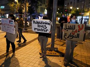 Israeli demonstrators carry placards during a demonstration condemning the shooting of Iyad Hallak, a disabled Palestinian man who was shot dead by Israeli police after they mistakenly thought he was armed with a pistol, in Jerusalem on May 30, 2020. Ahmad GHARABLI / AFP