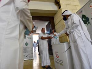 A Saudi medical worker sanitises the hands of a worshipper upon his arrival to perform noon prayer at Al-Rajhi mosque in the capital Riyadh on May 31 ,2020, after authorities eased lockdown measures for prayers in mosques. FAYEZ NURELDINE / AFP