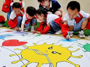 Childern draw an image showing people's efforts against the COVID-19 coronavirus at a kindergarten during the Childern's Day in Shangrao in China's central Jiangxi province on June 1, 2020. STR / AFP
