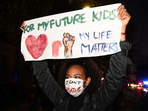 A protesters holds a banner and shout slogans during a rally for justice in Sydney on June 2, 2020, against the deaths of members of the Aboriginal community in Australia and the death of George Floyd, an unarmed black man who died in police custody in the US city of Minneapolis which has sparked violent protests across the US. PETER PARKS / AFP