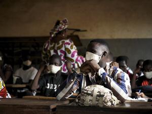 A Malian pupil wears a face mask in the classroom of a school as the government decided to resume lessons after two months of closure due to the spread of COVID-19 coronavirus, in Bamako on June 2, 2020. All the students have been provided with masks to wear mandatorily and the lessons have been reorganised in order to have a maximum number of 25 students per classroom. MICHELE CATTANI / AFP