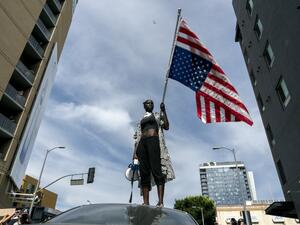 A protesters takes a moment while speaking to the crowd as they march through Hollywood during a demonstration over the death of George Floyd while in Minneapolis Police custody, in Los Angeles, California, June 2, 2020. Anti-racism protests have put several US cities under curfew to suppress rioting, following the death of George Floyd in police custody. Kyle Grillot / AFP