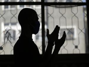 A mask-clad Palestinian man takes part in the noon (Dhuhr) prayers at the Al-Abrar mosque in Rafah in the sothern Gaza Strip on June 3, 2020, after local authorities who had shut down mosques due to the coronavirus allowed them to reaopen. SAID KHATIB / AFP