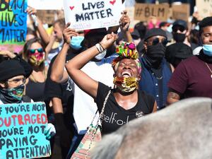 Monique Gray leads a crowd of protesters in a back and forth chant in support of George Floyd and against police brutality near Dolores Park in San Francisco, California on June 03, 2020. Thousands of people gathered at Dolores Park and marched through the city in support of George Floyd and against police brutality. Josh Edelson / AFP