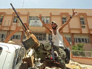 A fighter loyal to Libya's UN-recognised Government of National Accord (GNA) poses for a picture while seated in the turret a technical (pickup truck mounted with turret) in the town of Tarhuna, about 65 kilometres southeast of the capital Tripoli on June 5, 2020, after the area was taken over by pro-GNA forces from rival forces loyal to strongman Khalifa Haftar. Mahmud TURKIA / AFP