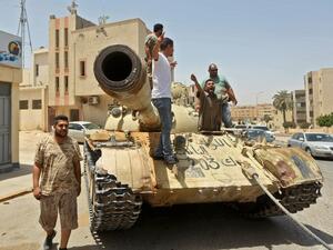 Fighters loyal to Libya's UN-recognised Government of National Accord (GNA) stand atop a tank in the town of Tarhuna, about 65 kilometres southeast of the capital Tripoli on June 5, 2020, after the area was taken over by pro-GNA forces from rival forces loyal to strongman Khalifa Haftar. Mahmud TURKIA / AFP