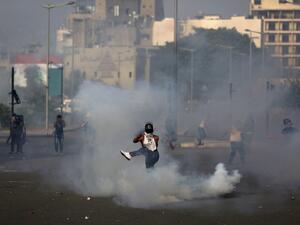 A Lebanese protester kicks a tear gas canister amid clashes with riot police following a demonstration in central Beirut, on June 6, 2020. Protesters poured into the streets of the Lebanese capital to decry the collapse of the economy, as clashes erupted between supporters and opponents of the Iran-backed Shiite group Hezbollah. PATRICK BAZ / AFP