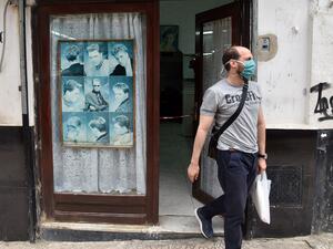 An Algerian man leaves a barber shop after getting a haircut in the capital Algiers on June 7, 2020, after authorities eased some restrictions put in place in a bid to fight the spread of the novel coronavirus. RYAD KRAMDI / AFP