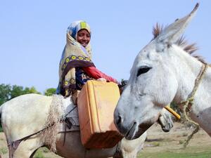 A Yemeni girl riding a donkey waits to fill jerrycans with water from a cistern at a make-shift camp for the internally displaced, in the northern Hajjah province, on June 7, 2020, amid a severe shortage of water. ESSA AHMED / AFP