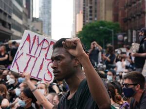 Protesters sit in the middle of 42nd Street near Times Square over the death of George Floyd by a Minneapolis police officer on June 7, 2020 in New York. Bryan R. Smith / AFP