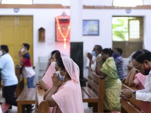 Catholic devotees wear face mask attend the Holy Mass at the Saint Joseph's Church on the first day after the reopening of religious services after the government eased restrictions imposed as a preventive measure against the COVID-19 coronavirus, in Hyderabad on June 8, 2020. NOAH SEELAM / AFP