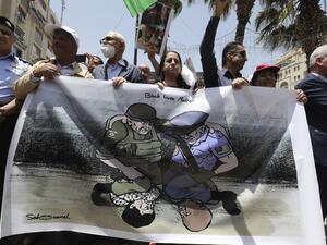 Palestinian demonstrators take part in a demonstration against police brutality and in support of US protesters over the death George Floyd, an unarmed black man who died after a white policeman knelt on his neck during an arrest in the US, in the centre of the occupied West Bank city of Ramallah on June 8, 2020. ABBAS MOMANI / AFP