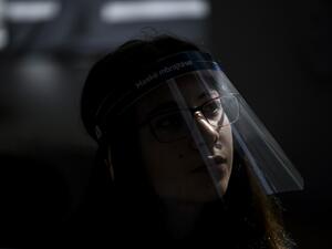 A student wearing a 3D printed face shield and gloves attends a class at the "Faik Konica" primary school in Pristina on June 9, 2020, as the schools in Kosovo gradually reopen, after almost three months of restrictions due to the risk of Covid-19 pandemic caused by the novel coronavirus. Armend NIMANI/AFP Armend NIMANI / AFP