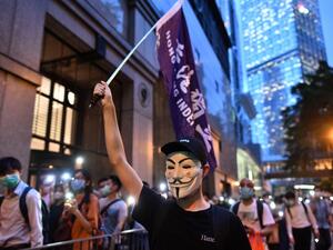 Pro-democracy protesters march in the Central district of Hong Kong on June 9, 2020, as the city marks the one-year anniversary since pro-democracy protests erupted following opposition to a bill allowing extraditions to mainland China. Anthony WALLACE / AFP