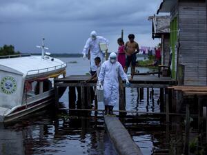 Health workers from the city of Melgaco arrive to a small riverside community at the Quara river, where eight families live without electricity, to give medical care to its residents amid concern over the spread of the COVID-19 coronavirus, in the southwest of Marajo Island, state of Para, Brazil, on June 9, 2020. TARSO SARRAF / AFP