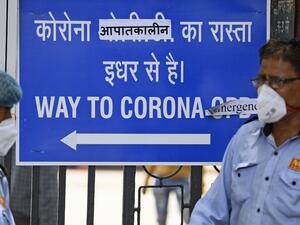 This photo taken on June 11, 2020 shows security guards at the entrance of the Lok Nayak Jai Prakash (LNJP) hospital in New Delhi. Ashwani Jain succumbed to the coronavirus in an ambulance as his family pleaded with several hospitals to take him in, the latest victim of the pandemic sweeping through Delhi and exposing a deadly shortage of hospital beds. Sajjad HUSSAIN / AFP