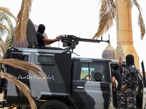 Members of security forces affiliated with the Libyan Government of National Accord (GNA)'s Interior Ministry stand at a make-shift checkpoint in the town of Tarhuna, about 65 kilometres southeast of the capital Tripoli on June 11, 2020. Mahmud TURKIA / AFP