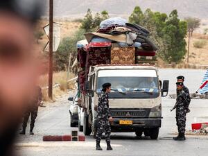 Members of security forces affiliated with the Libyan Government of National Accord (GNA)'s Interior Ministry stop a vehicle at a checkpoint in the town of Tarhuna, about 65 kilometres southeast of the capital Tripoli on June 11, 2020. Mahmud TURKIA / AFP