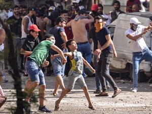 Lebanese anti-government protesters hurl rocks at soldiers amid clashes in the Bab al-Tabbaneh neighbourhood in the northern port city of Tripoli, on June 13, 2020, on the third consecutive day of angry demonstrations across the country due to a deepening economic crisis. The stand-off began after young men blocked a high way to prevent a number of trucks carrying produce destined to Syria from passing through, according to the official National News Agency, and the Lebanese Red Cross said it treated 9 peop