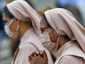 Nuns wearing a face mask attend the Pope's weekly Angelus prayer on June 14, 2020 at St. Peter's Square in The Vatican, as the city-state eases its lockdown aimed at curbing the spread of the COVID-19 infection, caused by the novel coronavirus. Tiziana FABI / AFP