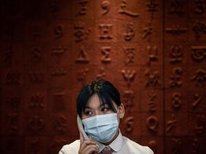 This photo taken on June 14, 2020 shows a staff member talking in the phone at Hubei Libruary as it reopens to the public in Wuhan in China's central Hubei province. STR / AFP