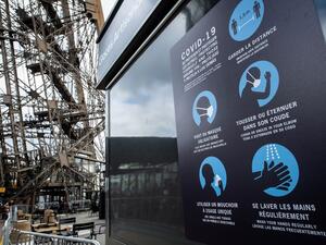 Sanitary instructions are seen on the waiting line to the Eiffel Tower, on June 15, 2020 in Paris, ahead of the partial reopening of the monument to the public as France eases lockdown measures taken to curb the spread of the Covid-19 pandemic (novel coronavirus). BERTRAND GUAY / AFP