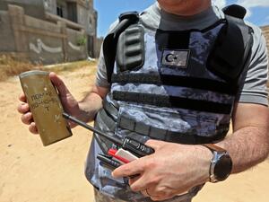 A Turkish deminer holds the remains of en explosive device in the Salah al-Din area, south of the Libyan capital Tripoli, on June 15, 2020. Human Rights Watch earlier this month accused pro-Haftar forces of laying Russian and Soviet-era landmines as they withdrew from Tripoli's southern districts. A team of Turkish deminers arrived in Tripoli last week to bring their expertise, under a broader military cooperation agreement signed late last year between Tripoli and Ankara. Mahmud TURKIA / AFP