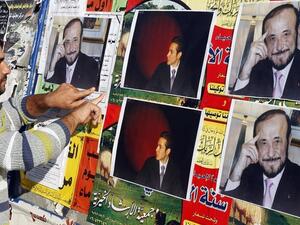 Above, pictures Rifaat Assad, right, the uncle of the Syrian president Bashar Assad, and Rifaat’s son Ribal are posted on a wall in Tripoli in this photo taken on December 6, 2007. (AFP)