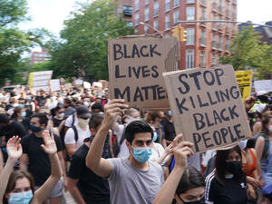 Protesters march and carry signs in the West Village as they demonstrate in outrage over the death of George Floyd, who died while in custody of the Minneapolis police, at a rally on May 30, 2020 in New York. AFP