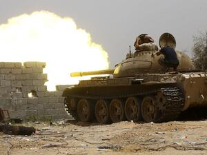 Forces loyal to the UN-recognised Government of National Accord (GNA) open tank fire from their position in the al-Sawani area south of the Libyan capital Tripoli during clashes with Haftar forces, June 13, 2019. (AFP)