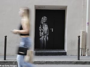 The artwork, which depicts a sorrowful girl in mourning, was cut out and snatched from the Bataclan concert hall in Paris in January 2019. it is shown above at the venue in 2018. (AFP)