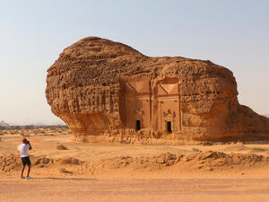 A tourist photographs Area C tombs at Madain Saleh Heritage Site. (Shutterstock/ File Photo)