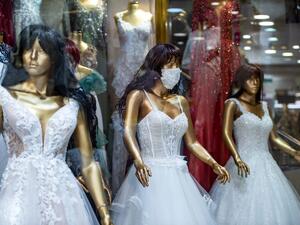 A picture taken on June 30, 2020 in Istanbul shows mannequins wearing wedding dress with matching protective mask displayed in a store amid the novel coronavirus (COVID-19) pandemic. (AFP)