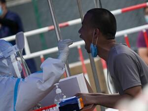 A man receives a swab test during widespread testing for the COVID-19 coronavirus outbreak in Beijing on July 1, 2020. WANG Zhao / AFP