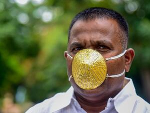 Businessman Shankar Kurhade wears a facemask made of gold and being worth 289,000 rupees amid concerns over the COVID-19 coronavirus outbreak, in Pune on July 4, 2020. Sanket WANKHADE / AFP