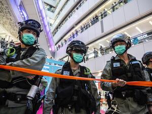 Riot police stand guard during a clearance operation during a demonstration in a mall in Hong Kong on July 6, 2020, in response to a new national security law introduced in the city which makes political views, slogans and signs advocating Hong Kong’s independence or liberation illegal. Hong Kongers are finding creative ways to voice dissent after Beijing blanketed the city in a new security law and police began making arrests for people displaying now forbidden political slogans. ISAAC LAWRENCE / AFP