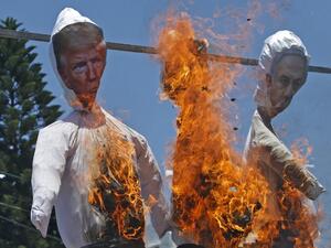 Palestinian supporters of al-Ahrar movement burn effigies depicting (L to R) US President Donald Trump, Trump's Middle East peace plan dubbed as the "Deal of the Century", and Israeli Prime Minister Benjamin Netanyahu, during a demonstration against Israel's plans to annex parts of the occupied West Bank, in Rafah in the southern Gaza Strip on July 7, 2020. Mohammed ABED / AFP