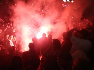 The demonstrators, who also lit flares and were seen throwing stones at police on local TV, chanted for President Aleksandar Vucic to "Resign!". OLIVER BUNIC / AFP