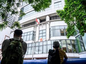 Journalists take photos outside the Office for Safeguarding National Security of the Central People's Government in the Hong Kong Special Administrative Region after its official inauguration in Hong Kong on July 8, 2020. China opened a new office for its security agents to operate openly in Hong Kong for the first time under a tough new law, transforming a hotel into the force's headquarters. Anthony WALLACE / AFP