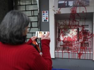 In this file photo taken on January 15, 2020 A woman pictures an ATM machine that was vandalised the previous night by anti-government protesters in the Lebanese capital Beirut. For months, Lebanon has grappled with its worst economic crisis since the 1975-1990 civil war. Tens of thousands have lost their jobs or part of their salaries, while a crippling dollar shortage has sparked rapid inflation.  ANWAR AMRO / AFP