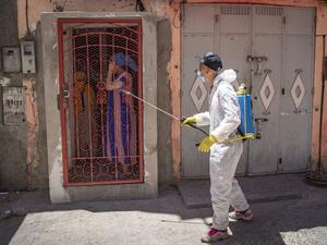 A Moroccan municipal worker disinfects outside a house in a closed street in the southern port city of Safi on June 9, 2020 after Moroccan authorities declared a total lockdown following the discovery of many new COVID-19 coronavirus cases there at a fish canning factory. FADEL SENNA / AFP