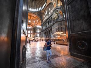 A woman walk through the huge doors of the Hagia Sophia museum in Istanbul, on July 10, 2020. Turkish President Recep Tayyip Erdogan announced on July 10, 2020 that the Hagia Sophia, one of the architectural wonders of the world, would be reopened for Muslim worship, sparking fury among Christian leaders and in neighbouring Greece. Ozan KOSE / AFP